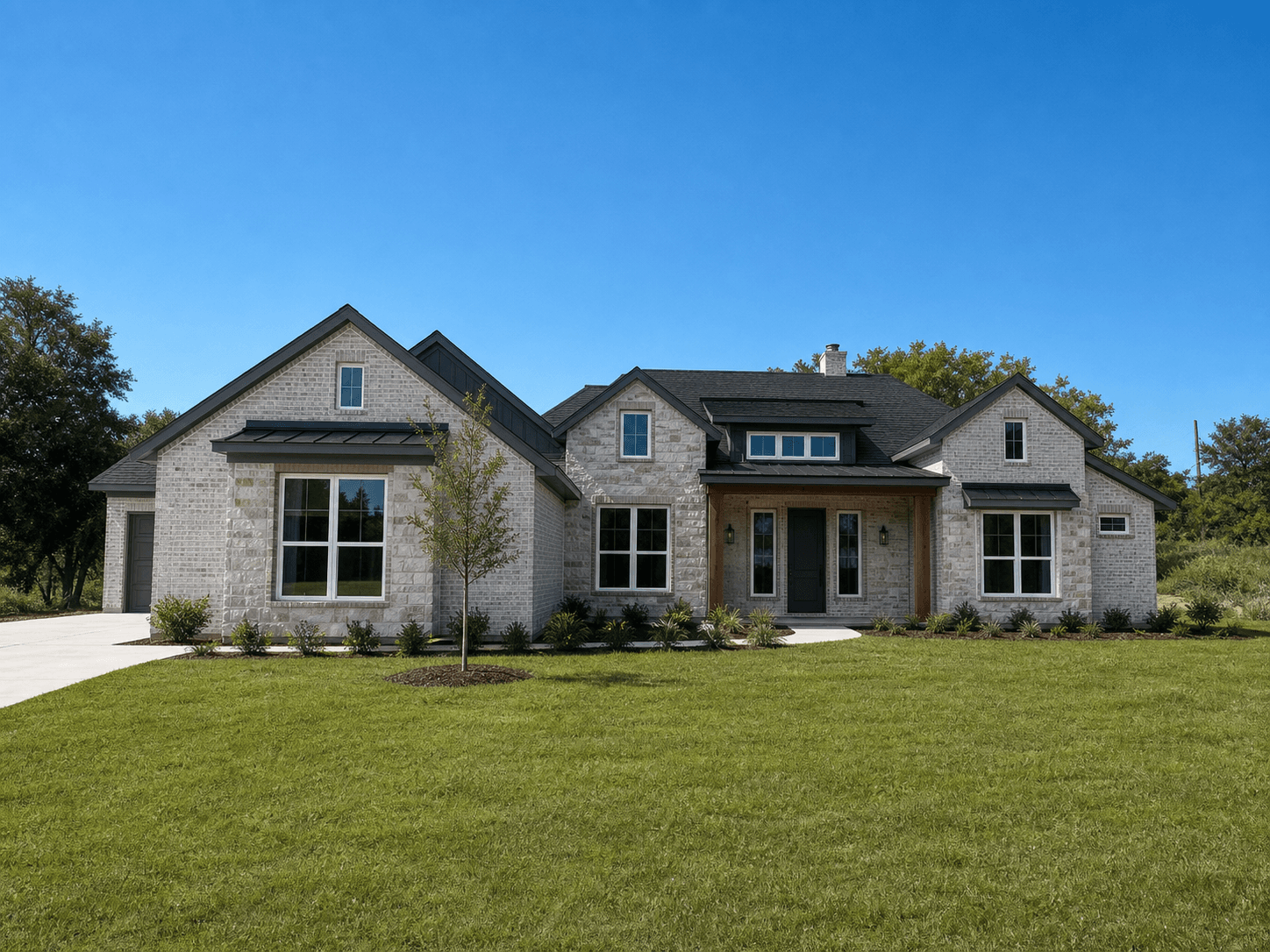 Conceptual finished rendering of 1000 VH Ranch Road with Alpine Fog brick, Lueders stone accents, and dark trim.