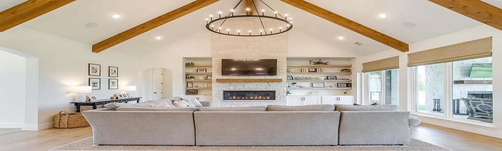 Abba River Homes living space with open kitchen and warm finishes.